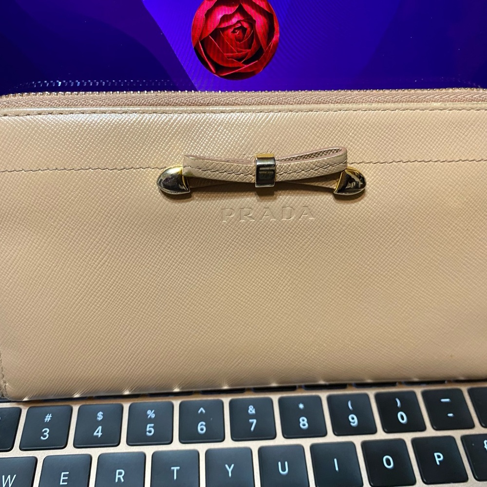 Vintage Milano Prada wallet with small bow, faint pink/beige color, rare item.